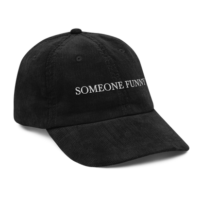 Black corduroy hat with 'SOMEONE FUNNY' text on a white background
