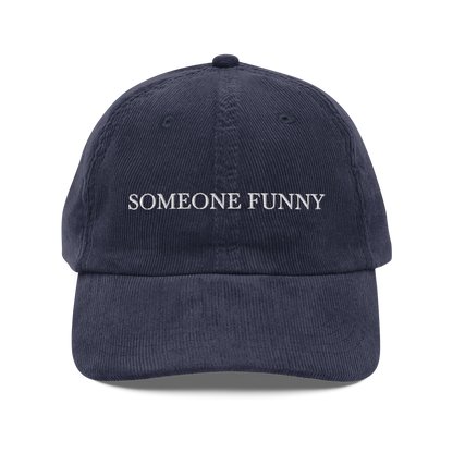 Navy blue cap with 'SOMEONE FUNNY' text on a white background