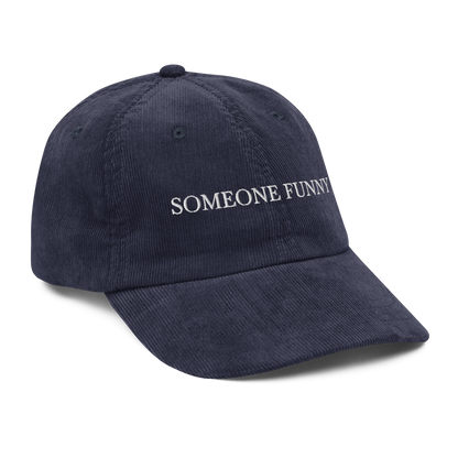 Navy blue cap with 'SOMEONE FUNNY' text on a white background