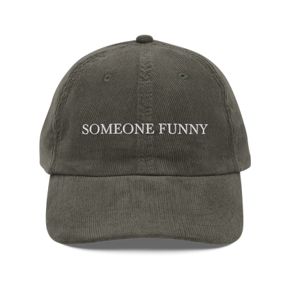 Olive green cap with 'SOMEONE FUNNY' text on a white background