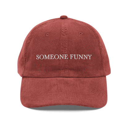 Red corduroy hat with 'SOMEONE FUNNY' text on a white background